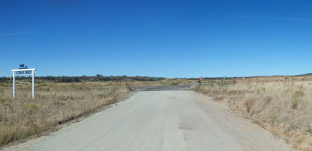 GDMBR: Paved New Mexico Highway 117 and the York Ranch Entrance sign.